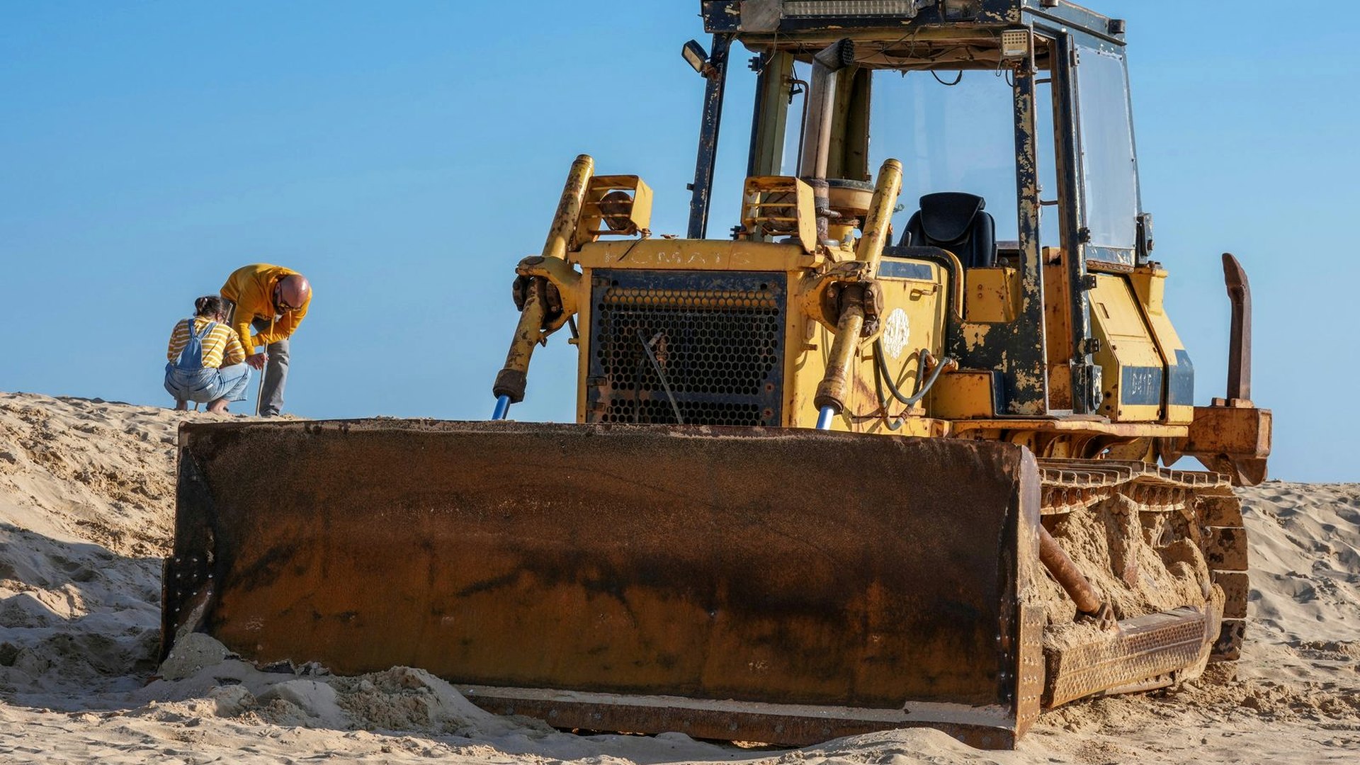 Bulldozer with a large front blade on an earthmoving site